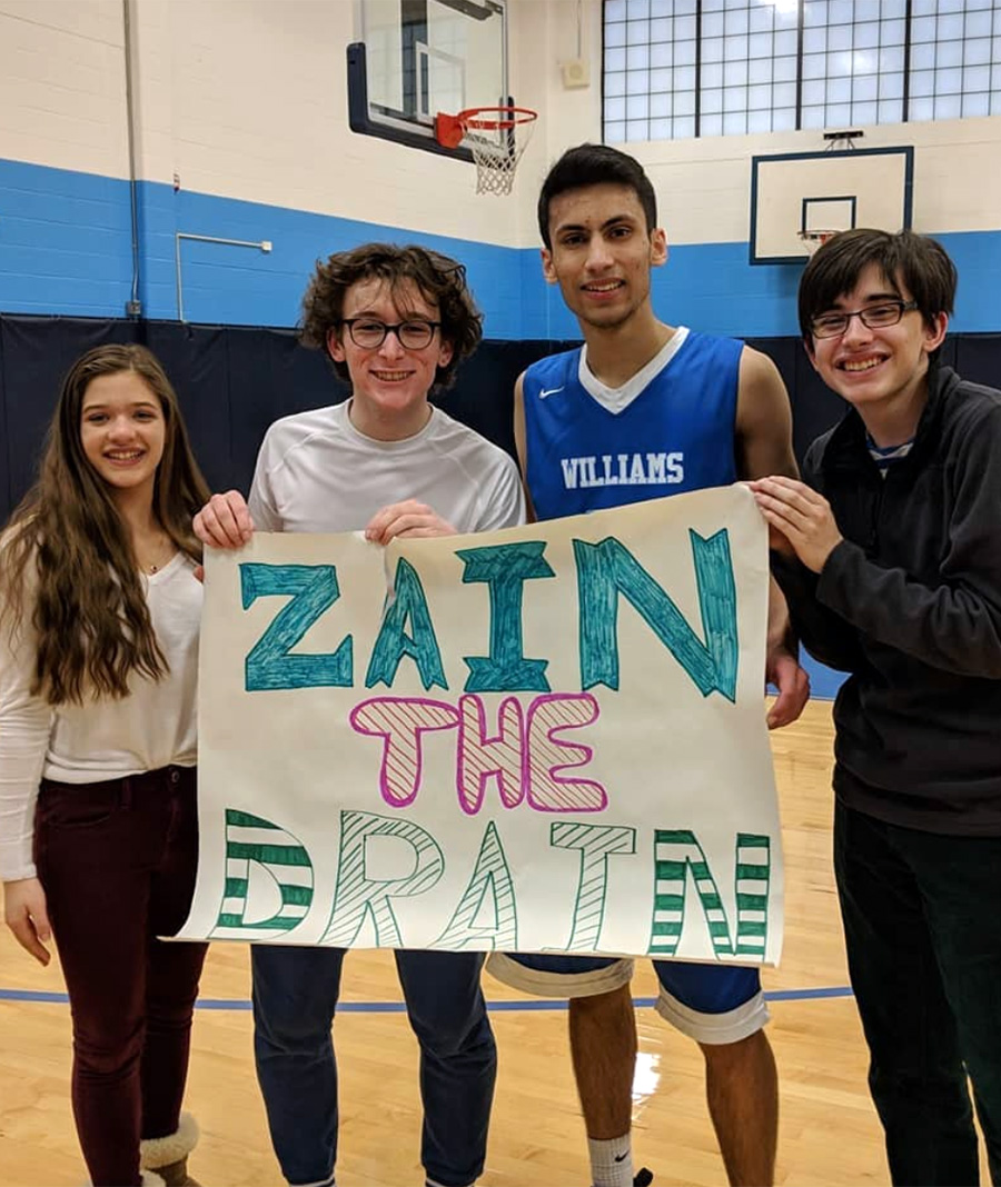 zain and friends holding sign that says zain the drain