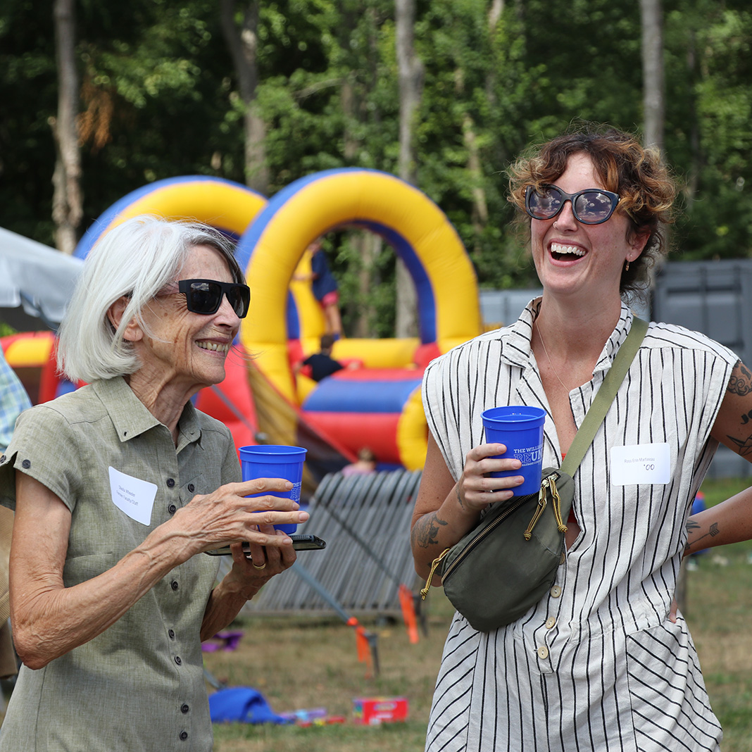 Williams School reunion attendees laugh in front of jolly jumper
